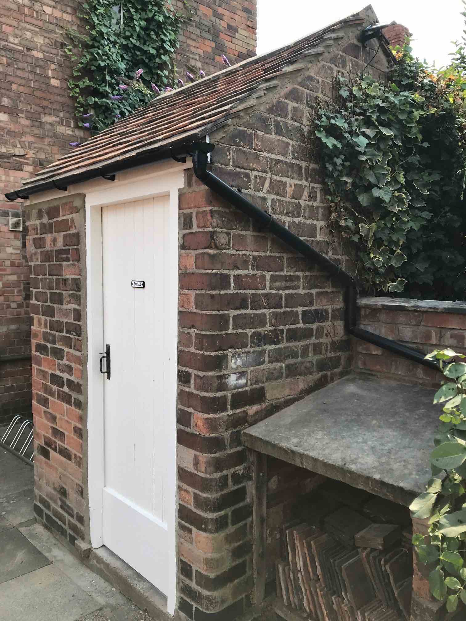 The re-roofed privy
